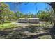 Charming tan single-story home with wood steps leading to the front door at 17913 Greensboro St, Spring Hill, FL 34610