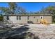 Exterior view of the house showing the siding, windows, and access to the backyard at 17913 Greensboro St, Spring Hill, FL 34610