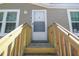 Upward view of the front door with new wooden steps and railings leading to the house entrance at 17913 Greensboro St, Spring Hill, FL 34610