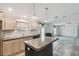 Kitchen features island, wood cabinets and open floor plan at 17913 Greensboro St, Spring Hill, FL 34610