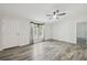 A bright, neutrally decorated living room with modern floors, a ceiling fan and a view of the front door at 17913 Greensboro St, Spring Hill, FL 34610