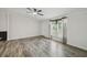 Bright living room featuring hardwood flooring, neutral walls, and a ceiling fan with window views at 17913 Greensboro St, Spring Hill, FL 34610