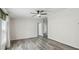 Bright living room with contemporary ceiling fan and wood-look laminate floors at 17913 Greensboro St, Spring Hill, FL 34610