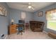 Cozy bedroom with wooden desk, plush chair and natural light at 18150 Leamington Ln, Land O Lakes, FL 34638