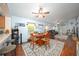 Open-concept dining area showcasing a wooden table, flowing into the living room and kitchen at 18150 Leamington Ln, Land O Lakes, FL 34638