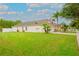 Property exterior showcasing well-kept lawn and a charming facade, highlighting its curb appeal at 18150 Leamington Ln, Land O Lakes, FL 34638