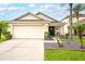 Charming single-Gathering house with well-manicured lawn, two-car garage, and attractive front porch at 18150 Leamington Ln, Land O Lakes, FL 34638