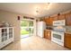 Bright kitchen with stainless steel appliances and sliding glass door to backyard at 18150 Leamington Ln, Land O Lakes, FL 34638