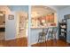 Open kitchen featuring bar seating, neutral countertops, and arched doorways at 18150 Leamington Ln, Land O Lakes, FL 34638