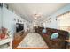 Spacious living room with wood floors, a comfortable brown sectional sofa, and ample natural light at 18150 Leamington Ln, Land O Lakes, FL 34638
