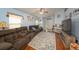 Inviting living space featuring comfortable seating, hardwood floors, and an abundance of natural light at 18150 Leamington Ln, Land O Lakes, FL 34638
