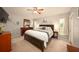 Bedroom featuring soft carpet, ceiling fan and ensuite bathroom at 18150 Leamington Ln, Land O Lakes, FL 34638