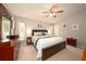 Comfortable main bedroom featuring plush carpet, a ceiling fan and neutral tones at 18150 Leamington Ln, Land O Lakes, FL 34638