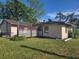 Spacious backyard with a lattice-covered porch at 204 Shore W Dr, Oldsmar, FL 34677