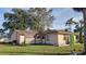 Exterior rear view of home with lattice and small covered entry at 204 Shore W Dr, Oldsmar, FL 34677