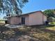 Back exterior with patio, sliding glass door, and HVAC unit at 204 Shore W Dr, Oldsmar, FL 34677