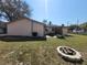 Exterior back of house with fire pit and small patio set at 204 Shore W Dr, Oldsmar, FL 34677