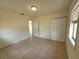Bedroom with tile floors, ceiling fan, and double-door closet at 204 Shore W Dr, Oldsmar, FL 34677