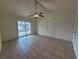 Bedroom featuring tile flooring, ceiling fan, sliding glass doors and closet at 204 Shore W Dr, Oldsmar, FL 34677