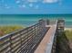 Boardwalk leading to tranquil turquoise waters, surrounded by vegetation at 204 Shore W Dr, Oldsmar, FL 34677