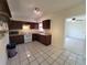 Functional kitchen featuring tile flooring, wooden cabinets, and an white electric range at 204 Shore W Dr, Oldsmar, FL 34677