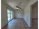Bright living room with tile flooring and sliding glass door leading to the backyard at 204 Shore W Dr, Oldsmar, FL 34677