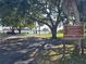 Park rules sign and peaceful waterfront backdrop, with shaded picnic area and tranquil waters at 204 Shore W Dr, Oldsmar, FL 34677