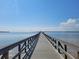 Scenic view of a long pier extending into a calm body of water under a clear blue sky at 204 Shore W Dr, Oldsmar, FL 34677