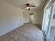Versatile room with tile floors, neutral walls, sliding doors, and modern ceiling fan at 204 Shore W Dr, Oldsmar, FL 34677