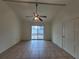 Spacious room featuring tile floors, sliding glass doors to the backyard, and a ceiling fan at 204 Shore W Dr, Oldsmar, FL 34677