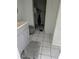 Functional walk-in closet featuring wire shelving, tile floors and white paint at 204 Shore W Dr, Oldsmar, FL 34677