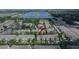 Community aerial view showcases townhomes near a scenic lake and convenient highway access at 2119 Kings Palace Dr, Riverview, FL 33578