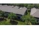 Aerial view of townhouse complex featuring screened patios, lush landscaping, and mature trees at 2119 Kings Palace Dr, Riverview, FL 33578
