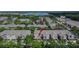 Community aerial view showcases townhomes near a scenic lake and convenient highway access at 2119 Kings Palace Dr, Riverview, FL 33578