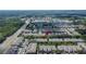 An aerial view of townhomes with well-maintained landscaping and a nearby shopping center at 2119 Kings Palace Dr, Riverview, FL 33578