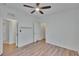 Bedroom shows wood-look floors and access to the closet and bathroom at 2119 Kings Palace Dr, Riverview, FL 33578