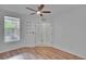 Bedroom featuring wood-look flooring, ceiling fan, and a window at 2119 Kings Palace Dr, Riverview, FL 33578