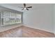 Bedroom featuring a ceiling fan, wood-look flooring, and a window at 2119 Kings Palace Dr, Riverview, FL 33578