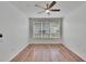 Bedroom featuring a ceiling fan, wood-look flooring, and a large window at 2119 Kings Palace Dr, Riverview, FL 33578