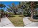 Exterior view showcasing the community common area featuring sidewalks, trees, and landscaping at 2119 Kings Palace Dr, Riverview, FL 33578