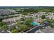 Aerial showcasing the community pool, parking, clubhouse and the surrounding well-maintained community grounds at 2119 Kings Palace Dr, Riverview, FL 33578