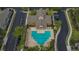 Aerial view of the pool and clubhouse, surrounded by visitor parking and lush landscaping at 2119 Kings Palace Dr, Riverview, FL 33578