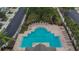 Aerial view of sparkling community pool with ample seating and shaded picnic tables at 2119 Kings Palace Dr, Riverview, FL 33578