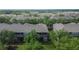 An aerial view features a screened-in porch with white railings amid lush trees at 2119 Kings Palace Dr, Riverview, FL 33578