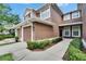 Exterior shot of a well-maintained townhome with a two-car garage and walkway to the front door at 2119 Kings Palace Dr, Riverview, FL 33578