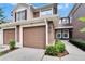 Charming townhome featuring a well-maintained exterior, a one-car garage, and beautiful landscaping at 2119 Kings Palace Dr, Riverview, FL 33578