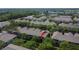 An aerial view of a home with a screened-in porch surrounded by trees in a townhome community at 2119 Kings Palace Dr, Riverview, FL 33578