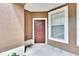 A view of the home's exterior with a solid front door and window at 2119 Kings Palace Dr, Riverview, FL 33578