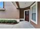 View of front entrance with solid door, window, and surrounding landscaping at 2119 Kings Palace Dr, Riverview, FL 33578