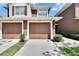 Exterior shot showcasing the attached garages of a multi-Gathering home with well-manicured lawns at 2119 Kings Palace Dr, Riverview, FL 33578